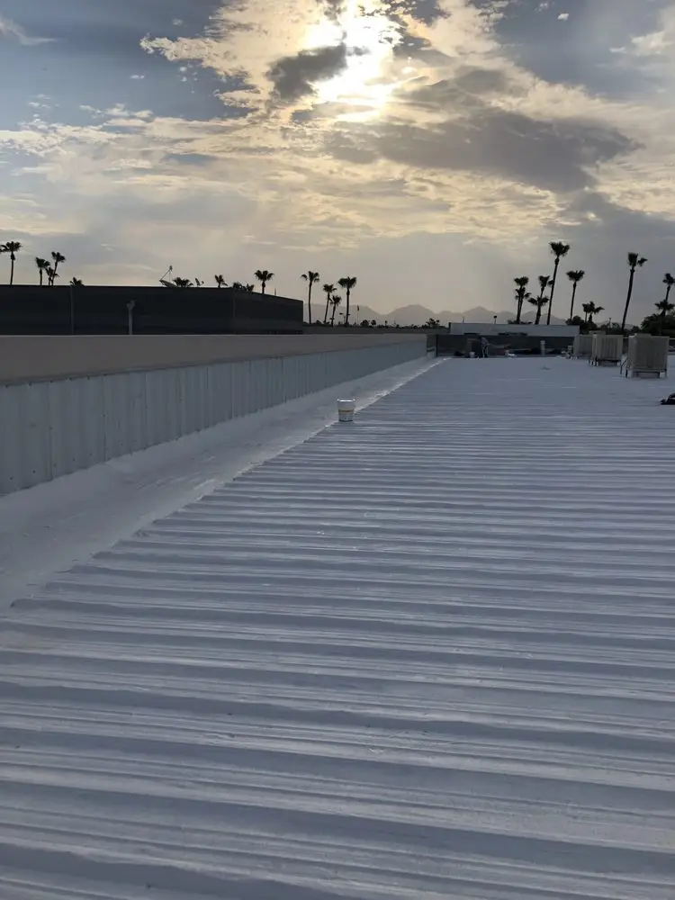 Commercial corrugated metal roof with a fresh white reflective coating in Phoenix