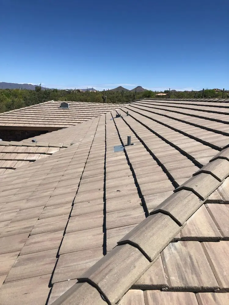 Finished concrete tile roof with desert foothills and saguaros in the background near Phoenix