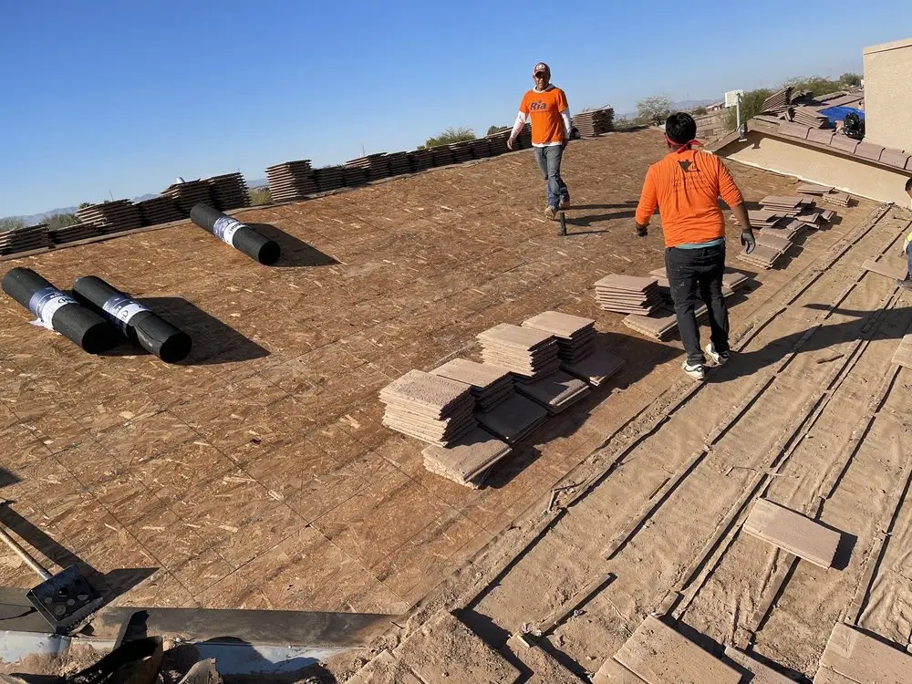 New OSB decking with concrete tiles staged for re-laying during a north Valley tile re-roof, by Leal Roofing
