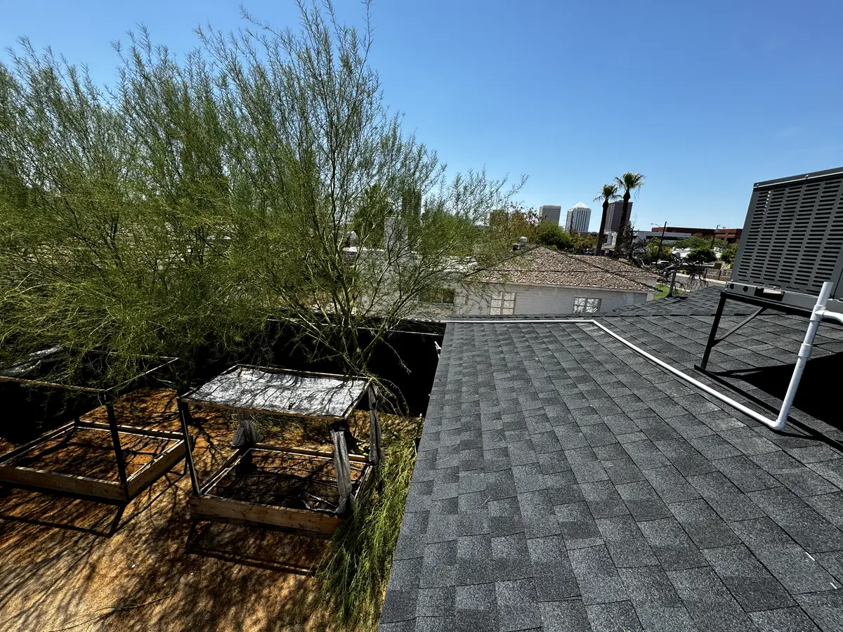 New GAF Timberline charcoal architectural shingle roof with the downtown Phoenix skyline behind it